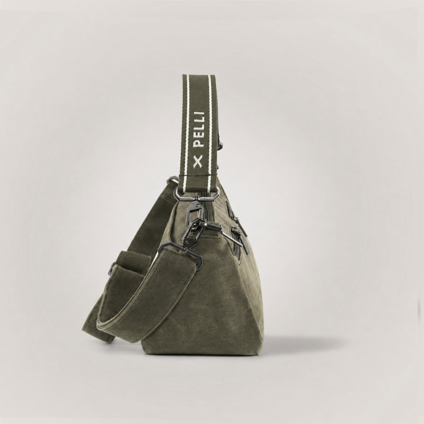 The Wanderer waxed canvas crossbody bag in Burnt Olive - side view